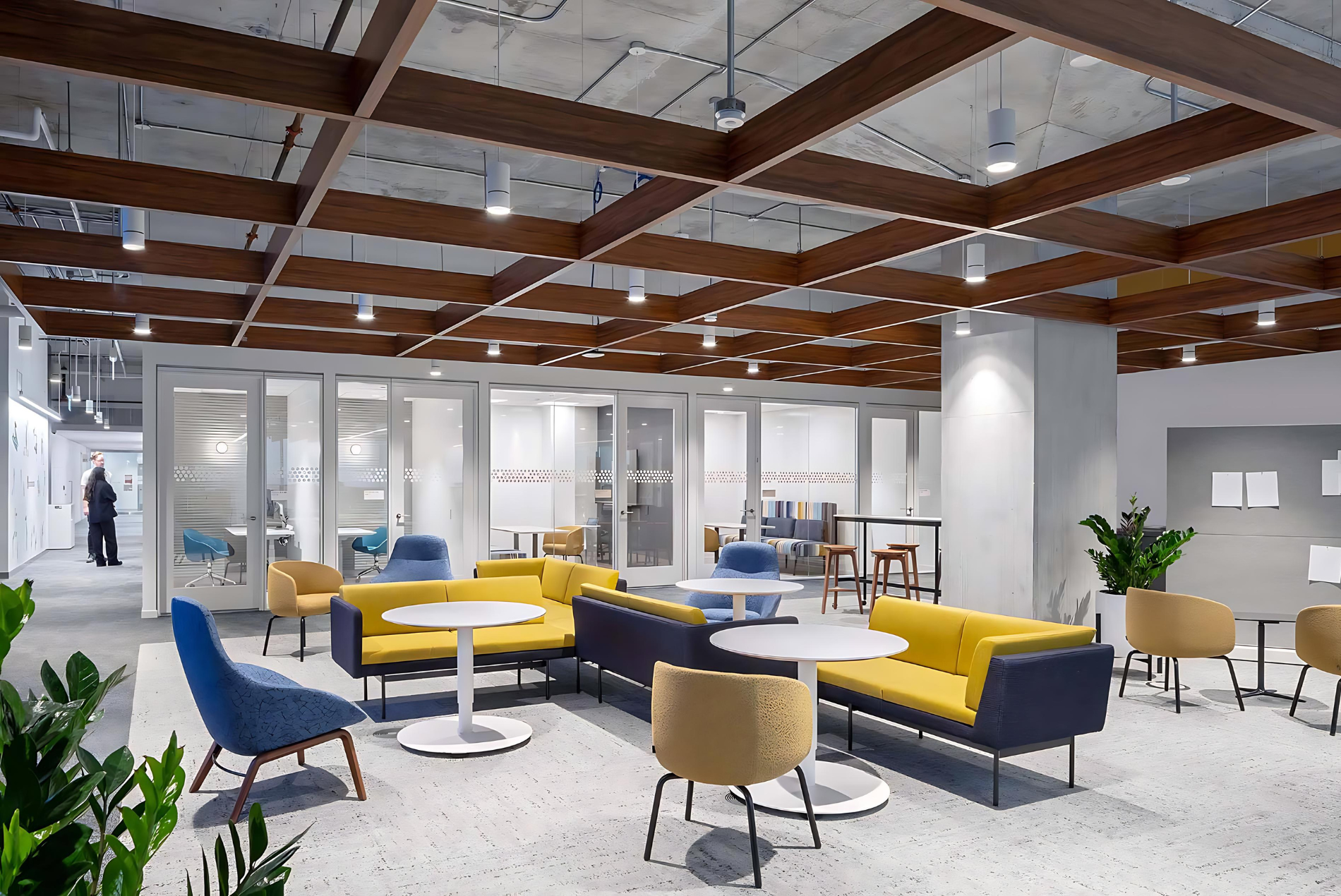 Intuit office lounge displaying a Tignum traditional starburst wood ceiling with vibrant yellow and blue seating.